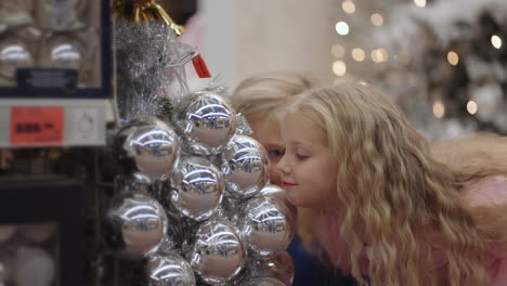 Kinder-Vergnügen-Sich-Im-Laden,-Schneiden-Grimassen-Und-Lachen-Beim-Betrachten-Der-Weihnachtskugeln